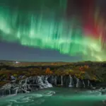Northern Lights over Hraunfossar waterfall during a tour with Private Iceland