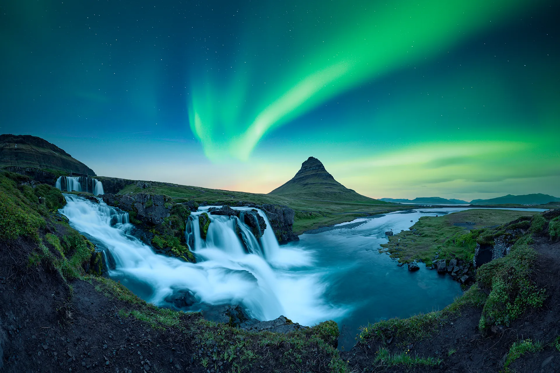 Kirkjufellsfoss waterfall under the northern lights with Arctic Exped